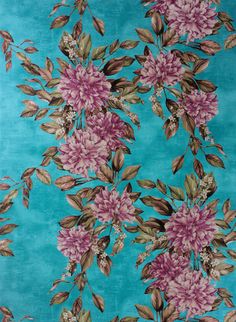 a blue rug with pink flowers on it and green leaves in the middle, against a teal background