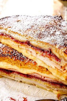 a stack of pancakes covered in powdered sugar