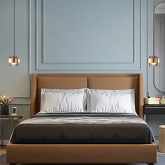 a bed with two pillows on top of it and a mirror above the headboard