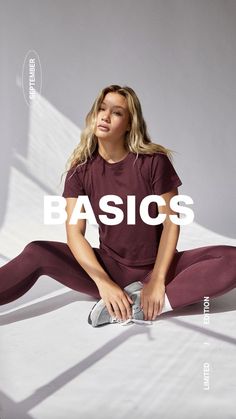 a woman is sitting on the floor with her legs crossed and wearing maroon leggings