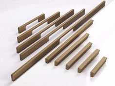 several different types of wooden handles on a white surface, including one for the door