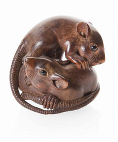 two wooden mice sitting on top of each other in the shape of a rat and mouse