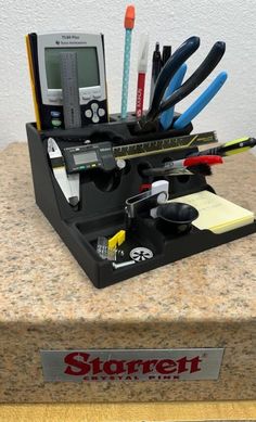 there is a desk organizer with pens, pencils and other office supplies in it