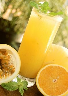 an orange juice and some fruit on a table