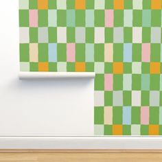 a green and pink checkered wallpaper in an empty room