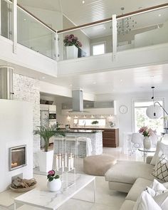 a living room filled with furniture and a fire place in the middle of a kitchen