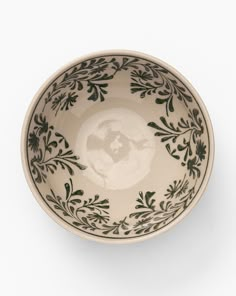 a black and white bowl on a white background with an image of the earth in it