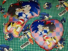 two sonic the hedgehog heart cushions on a green and white checkered tablecloth