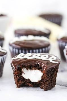 chocolate cupcakes with white frosting on top