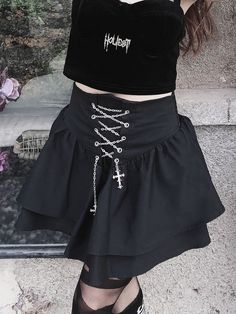 Elevate your gothic style with this stunning black high waist gothic short skirt. Featuring a high waist design and adorned with edgy cross chains, this skirt exudes dark elegance. The short length adds a touch of sass, making it perfect for both casual and formal occasions. Crafted from high-quality materials, this skirt offers a comfortable fit and excellent durability. Pair it with your favorite fishnet stockings and combat boots for a complete gothic look that is sure to turn heads.   Note: Black Gothic Mini Skirt For Alternative Fashion, Gothic High-waist Mini Skirt, Gothic High Waist Skirt For Alternative Fashion, Gothic High-waist Mini Skirt For Alternative Fashion, Gothic High Waist Mini Skirt For Alternative Fashion, Gothic Mini Skirt For Alternative Fashion, Gothic High Waist Skirt For Party, Black Gothic Mini Skirt, Gothic Black Mini Skirt