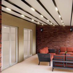 an outdoor seating area with brick walls and white trimmings on the ceiling is lit by recessed lights