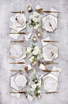 a table setting with white flowers and gold chargers on it is featured in the instagram