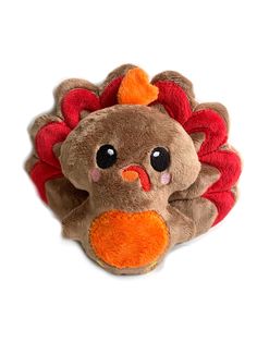 a stuffed turkey is laying down on the floor with its eyes wide open and it's head tilted to the side