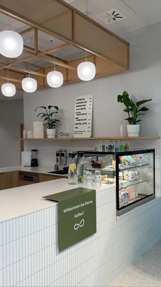 the front counter of a store with lights above it