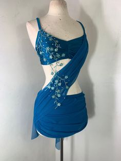 a mannequin wearing a blue dress with flowers on it