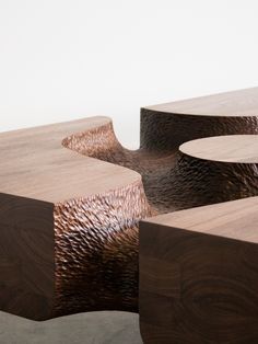 the table is made out of wood and has wavy designs on it