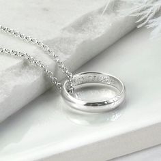 "Our beautiful Sterling Silver Secret Message Ring Necklace is the perfect way to give someone special a stunning necklace complete with a secret message they can carry with them everywhere. The necklace is available with either a luxurious polished finish or hammered finished ring. We can engrave the inside of these rings with your secret message. The ring comes one a fine belcher chain, available in five different lengths. So why not make this a truly personal gift by having your own special message engraved, by us To order this necklace simply select the chain length and the font you would like us to use from the drop down menus, you can select \"no engraving\" if you would like us to leave it blank. Then at the checkout, let us know which finish you would like, either polished or hamme Necklace To Put Ring On, Winx Saga, Wedding Ring Necklaces, Secret Messages, Square Rings, Engraved Items, Stunning Necklace, The Promise, Wren