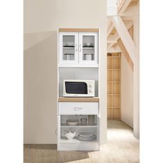 a white microwave oven sitting on top of a wooden shelf next to a wall mounted cabinet