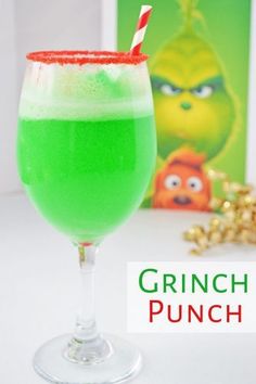 a green drink in a glass with a red and white straw sticking out of it