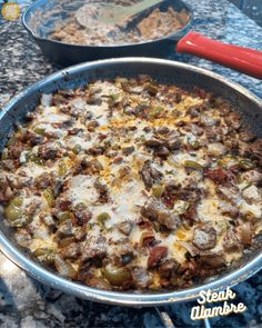 a pan filled with food sitting on top of a counter