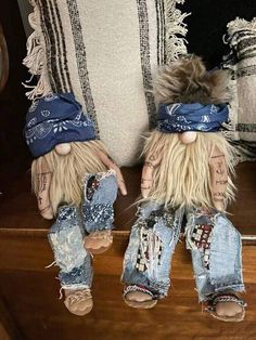 two stuffed animals wearing jeans and bandannas on their heads, sitting next to each other