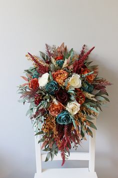 a bouquet of flowers sitting on top of a white chair