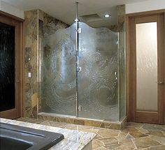 a bathroom with a walk in shower next to a bathtub and tiled flooring