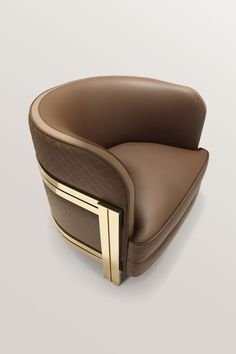 a brown leather chair with gold trimmings on the arm and back, sitting in front of a white background