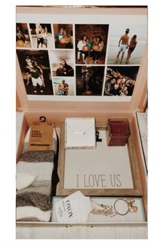 an open suitcase filled with personal items and pictures on the wall behind it that says, i love us