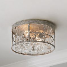 a light fixture in a room with white walls and ceiling lights on top of it