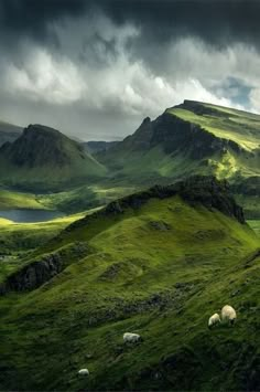 an image of some mountains with sheep in the grass and clouds above them on instagram