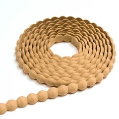 a close up of a rope on a white surface with a circular hole in the middle