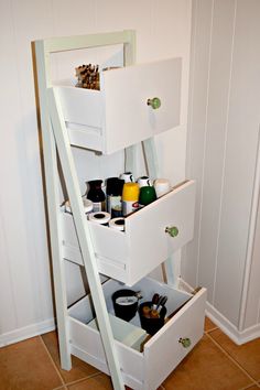 a white shelf with drawers on top of it