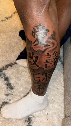 a man's leg with chinese writing on it