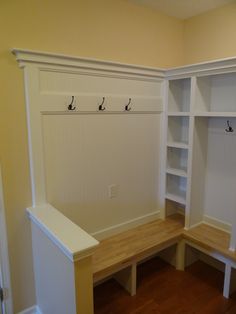 an empty room with benches and coat racks