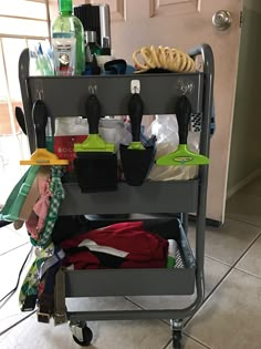 a cart filled with lots of items on top of a tiled floor