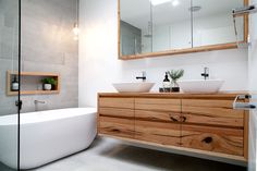 a bathroom with two sinks and a large bathtub in it's center area