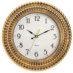 a clock that is gold and white with numbers on the face, in front of a white background