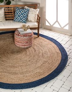 a living room with a couch and rug on the floor