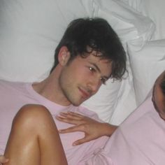 a man and woman laying in bed together