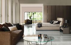 a living room filled with furniture and a glass table in front of the couches