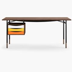 a desk with an orange, yellow and black drawer underneath it on a white background