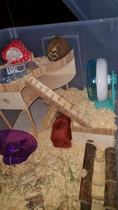 there are many toys in the bins on this table and one is made out of wood