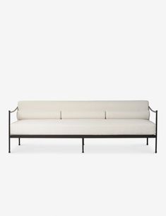 a white couch sitting on top of a metal frame