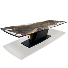 the table is made out of wood and has a glass top with an abstract design on it