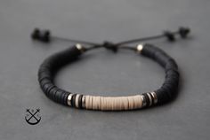 "This is a listing for custom heishi 2 colour bracelet. You can choose or: 1. Main colour: Black with gold finishing and a bit of beige 2. Main colour: Black with silver finishing and a bit of beige - 100% handmade in France - the bracelet will wrap only once around your wrist and makes for a nice subtle accessory bringing out the outdoor and adventurous person in you. - the bracelet comes in a fabric gift bag ready to offered as a present. Colours used in this pictures are Beige and Black.  SIZ Heishi Bracelet, Womens Bracelet, Her And Him, Bracelet In Silver, Unisex Gift, Sliding Knot, Heishi Beads, Unisex Gifts, Fabric Gift Bags