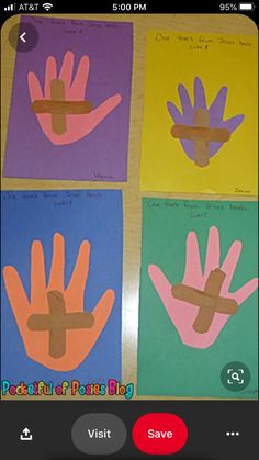 four handprints with different colors on them, each depicting a cross in the middle