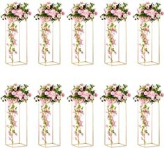 six tall clear vases with pink flowers and greenery on each one, all in different angles