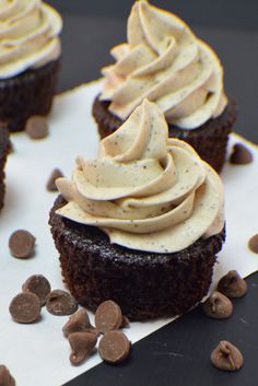 chocolate cupcakes with white frosting and chocolate chips