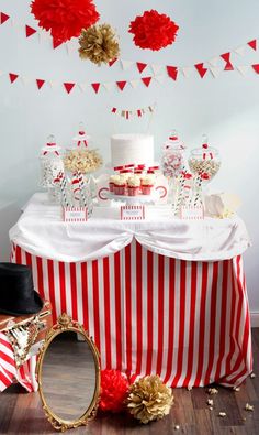 a red and white striped table cloth topped with a cake